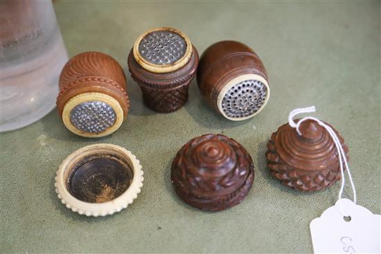 Five 19th century coquilla nut nutmeg graters and two condiment shakers, largest 7.2cm